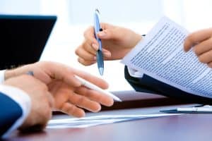 Two people going through some printed documents